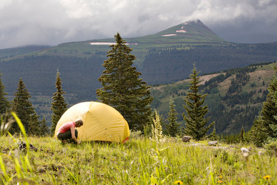 One woman making camp wile backpacking near Andrews Lake, Molas Pass, on the way to Crater Lake by the Twighlight Peaks. San Juan Mountains, Weminuche Wilderness, CO