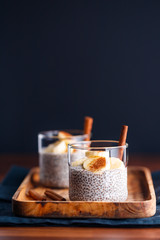 Chia pudding with coconut milk and banana in glasses on a table. Vegetarian healthy dessert.