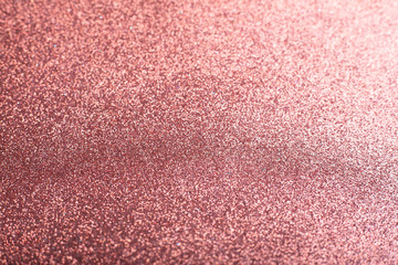 Fototapeta premium Rose gold pink glitter background texture for Valentines day, Christmas wallpaper decoration, wedding invitation card. Abstract sparkling shiny wrapping paper background, copy space, defocused lights.