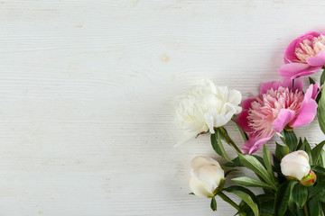 Beautiful peony flowers closeup over textured background with a lot of copy space for text. International women's mother's valentine's first spring day. Close up, top view, backdrop, flat lay.
