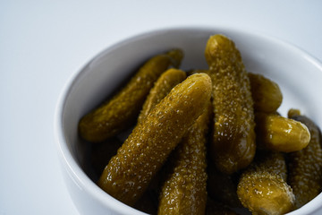 small pickles in ceramic bowl