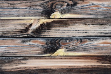 Wooden, untreated boards, sometimes blackened.