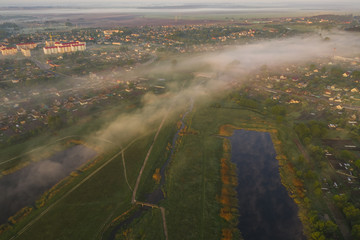 Aerial view - Morning fog in a small town on a summer morning