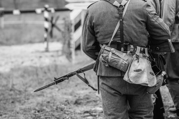 German soldier during the second world war in uniform with a rifle and bayonet with a knife. Black...