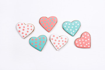 Gingerbread cookies with frosting in the shape of a heart on white background. Valentines day concept. Flat lay, top view.