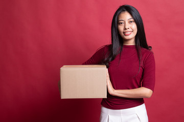 Delivery, relocation and unpacking.  young asian woman holding cardboard box.