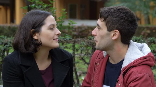 First kiss, Romance, love. young lovers in the park at first date kissing.