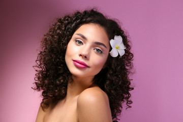 Naklejka premium Beautiful woman with with light make up and curly hairstyle wearing shoulderless dress.