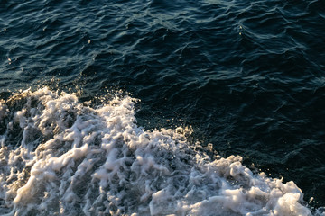 oceans' wave and foam at sunset. take from the top. close up