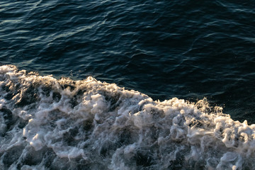 oceans' wave and foam at sunset. take from the top. close up