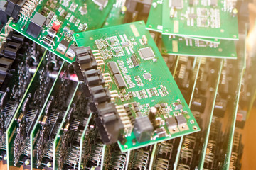 Automotive Printed Circuit Boards with Surface Mounted Components. PCb Lying On Top of Batch. Shallow DOF. Lens FlareAdded.