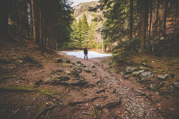 man hiker thinking in the forest in mountain - time to disconnect concept - intentional artificial flare image