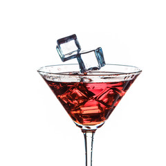 Closeup of Icecubes in Colorful Liquid. Falling to Goblet with Droplets. Against White Background.