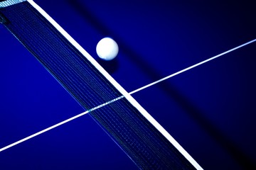 background with ball for table tennis over a table in blue with white lines