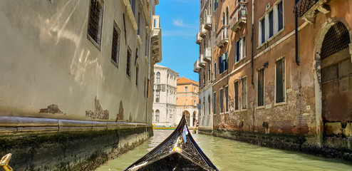 Gondola ride in Venice, past rundown old buildings