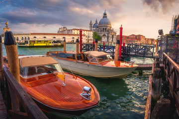 Venice, Italy - May 2, 2019: A beautiful panorama  on historic attraction  Basilica di Santa Maria, Venice. A view of famous Canal Grande is crowded by boats. 