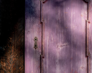 Purple door with shadows in old mantion