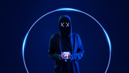 Dangerous hooded hacker with gift in hands. Internet, cyber crime, cyber attack, system breaking and malware concept. Dark face. Anonymous. Blue neon light eyes.