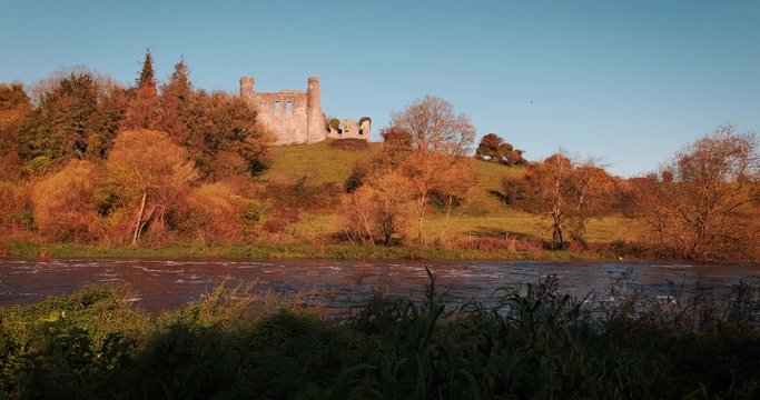 Colorful 4K video of Boyne valey, river and surroundings with Dunmoe castle on thee background, during sunny golden autumn evening, Co. Meath, Ireland