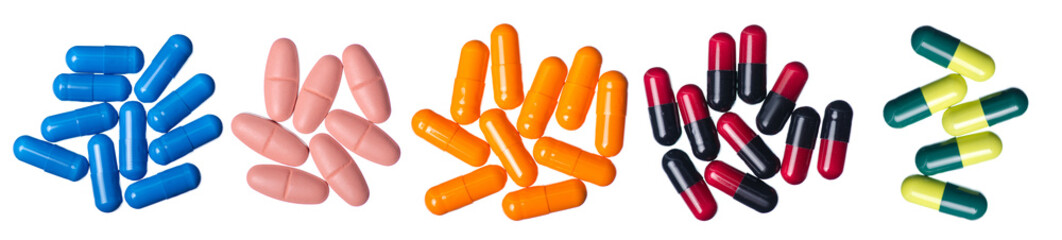 Different colored medicine pills capsules isolated on a white background.