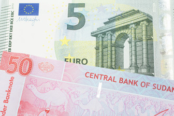 A five Euro, European Union bill with a fifty pound note from Sudan close up in macro