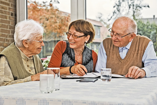 Elderly Couple And Dughter Making Plans