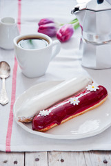 Breakfast with French colorful eclairs with coffee cup