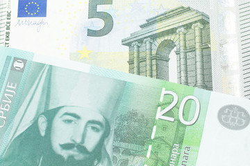 A twenty Serbian dinar bank note, close up in macro with a five euro German bank note
