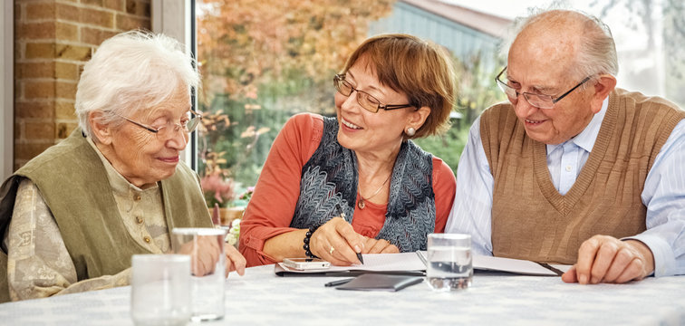 Elderly Couple And Dughter Making Plans