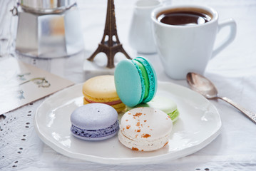 Breakfast with French colorful macarons with coffee cup