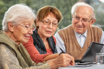Elderly Couple and Daughter Making Plans