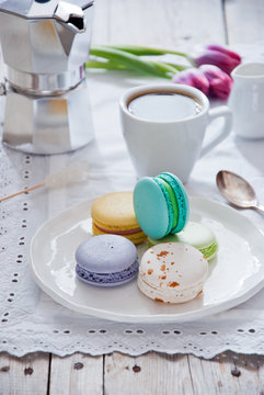 Breakfast with French colorful macarons with coffee cup