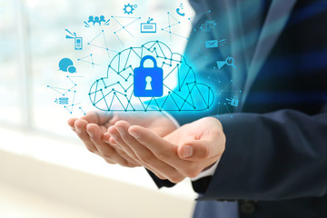 Businessman with hologram projection of cloud storage service in office, closeup