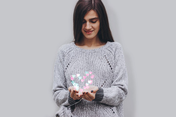 Valentine's day. Girl holds a heart-shaped garland.