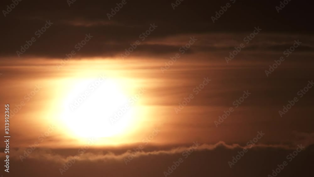Canvas Prints sunrise through cloud layers on warm sky timelapse