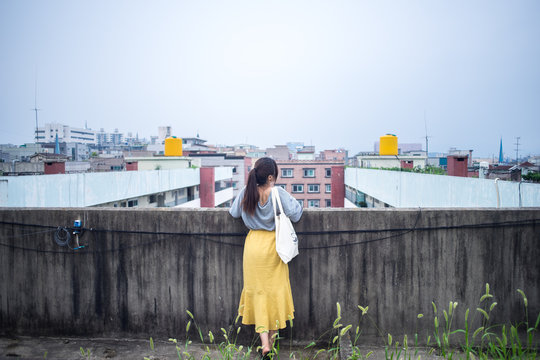 A woman in a yellow skirt and a yellow back barrel.