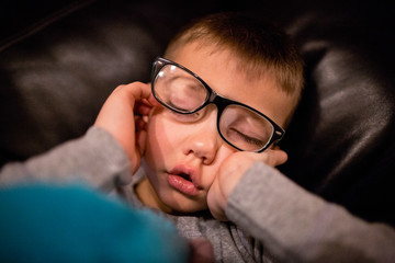 Young tired boy fell asleep suddenly