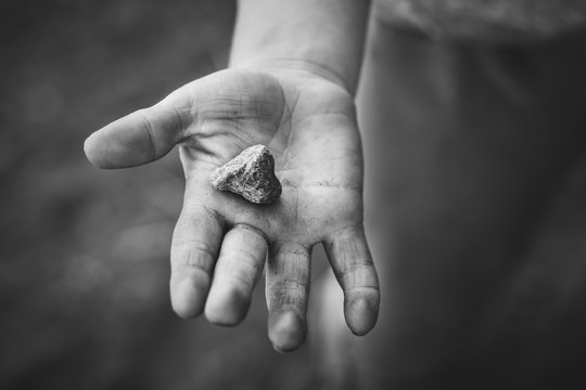 dirty boy hand with rock