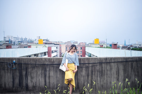 A woman in a yellow skirt and a yellow back barrel.