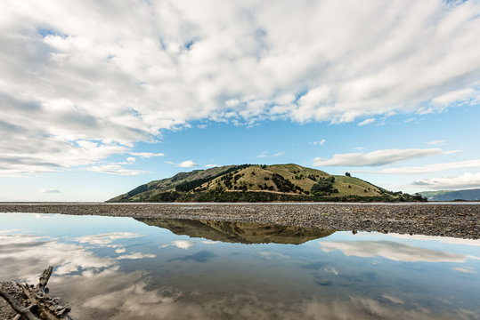 Landscape photo with reflection of Pepin Island in Cable Bay, NZ