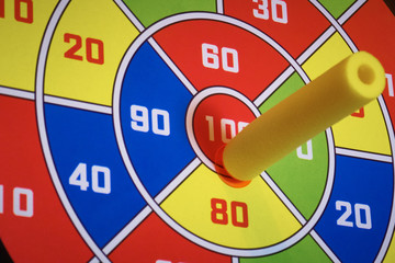 Velcro Darts, hitting the target with a bullet-dart with Velcro, close-up.