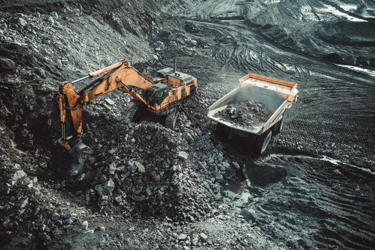 Excavator Loading Coal Truck from Aerial View