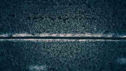 Top view of road in forest with first winter snow