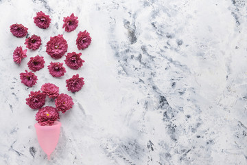 Menstrual cup with flowers on white background. Menstruation concept