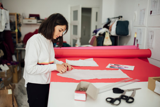 young woman working with a sewing pattern in a fashion design