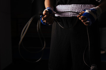 Closeup of boxer holding a jump rope to start warming up.