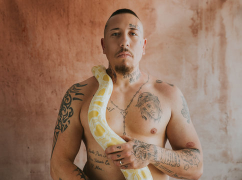 Portrait of man holding snake