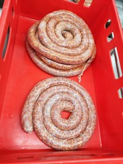 Freshly made homemade sausages in a red box