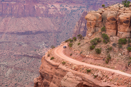 Car Traversing a hairpin turn on White Rim road, from Shafer Canyon