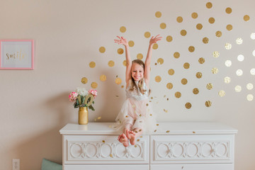 Girl celebrating in a pink and gold theme